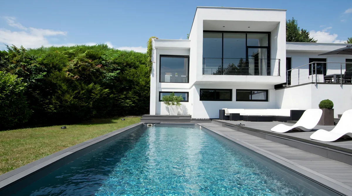a modern white house with a swimming pool